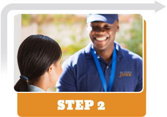 A smiling All Things Junk employee